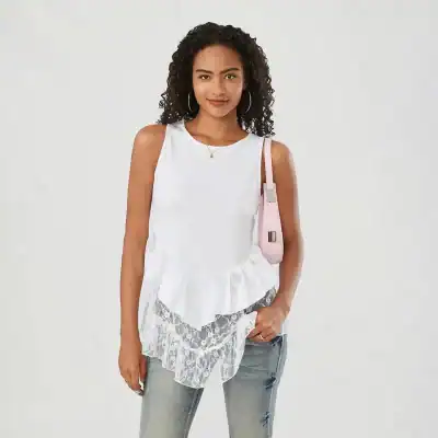Stylish white sleeveless top with ruffled lace detail, perfect for trendy fashion and casual wear. Made with breathable fabric for a comfortable fit and chic appearance.