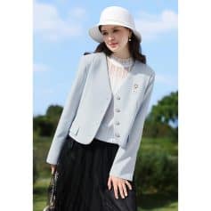 Stylish women's blazer, white jacket, and fashionable accessories showcased outdoors, perfect for office or casual wear.