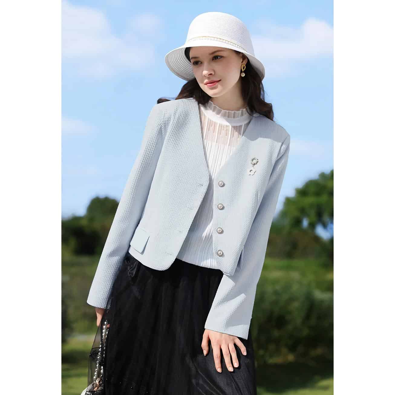 Stylish women's blazer, white jacket, and fashionable accessories showcased outdoors, perfect for office or casual wear.