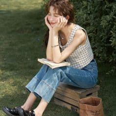 Beautiful young woman enjoying reading outside, promoting health and wellness through opt-friendly lifestyle choices.