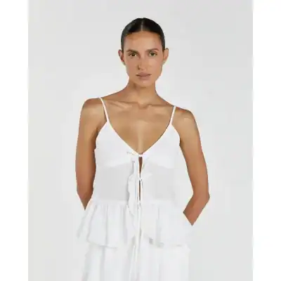 Elegant white sleeveless dress with tie-front detail, perfect for daytime casual wear and fashion accessories.