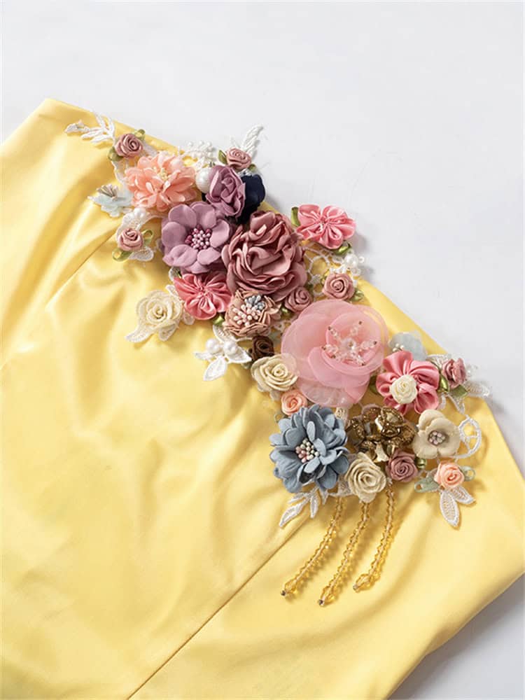 Beautiful floral embellishments and pearls on soft yellow fabric for bridal and special occasion wear. Perfect for wedding gowns, accessories, and elegant styling.