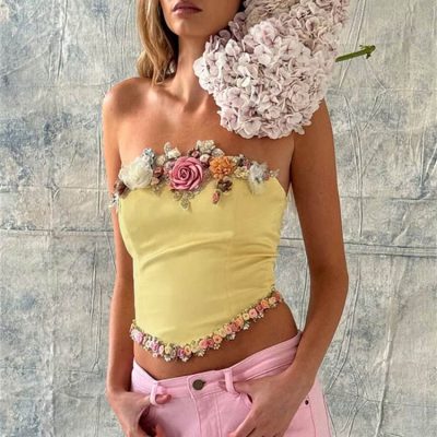 Elegant yellow top with 3D floral embellishments, floral border, and unique design. Perfect for stylish occasions and fashion-forward looks.