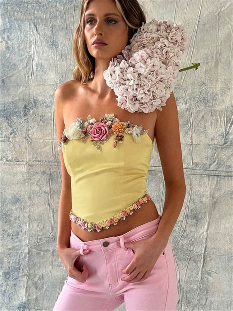 Elegant yellow top with 3D floral embellishments, floral border, and unique design. Perfect for stylish occasions and fashion-forward looks.