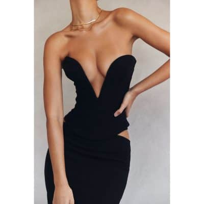 Stylish black strapless dress emphasizing the deep plunging neckline, perfect for evening wear or special occasions, showcasing fashion and elegance.