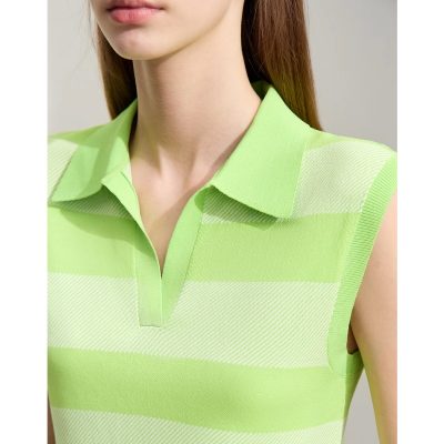Close-up of a woman wearing a bright green sleeveless polo shirt with subtle textured stripes, showcasing stylish and comfortable fashion options for modern women.