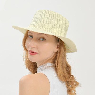 Beautiful woman wearing a stylish wide-brim straw hat, perfect for summer sun protection and fashionable outdoor wear. Ideal for enhancing your optical and fashion accessories collection.