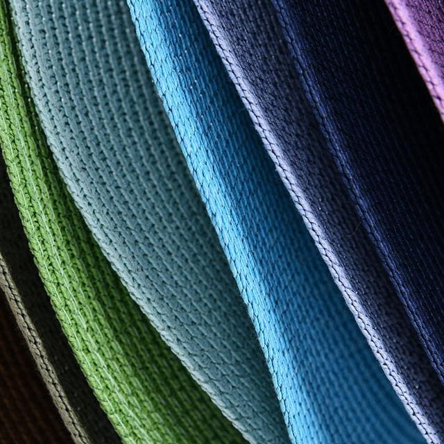 Brightly colored microfiber cleaning cloths in green, blue, and purple, ideal for delicate lens cleaning and optical product maintenance.