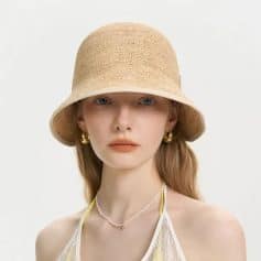 A stylish wide-brim straw sun hat perfect for summer outdoor activities, combining fashion with sun protection.