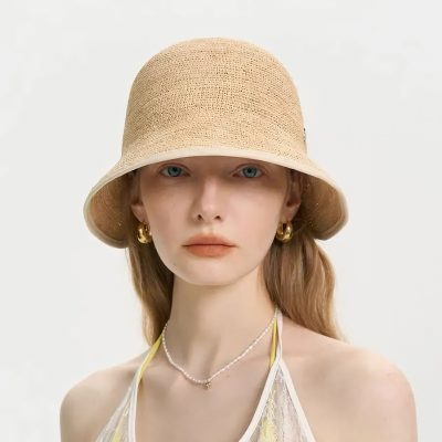 A stylish wide-brim straw sun hat perfect for summer outdoor activities, combining fashion with sun protection.