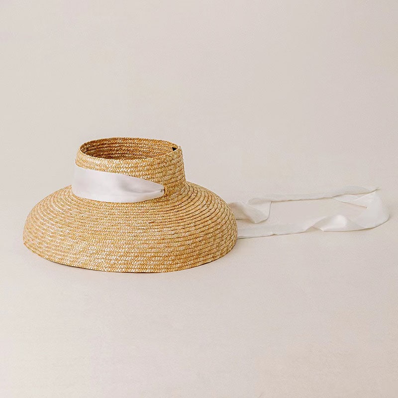 Elegant straw sun hat with white satin band, perfect for summer fashion and outdoor protection. Stylish accessory for warm weather, offering sun protection and chic summer style.