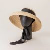 Elegant straw sun hat with black ribbon for sun protection and fashion. Perfect for outdoor activities, beach outings, and summer accessories.