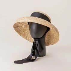 Elegant straw sun hat with black ribbon for sun protection and fashion. Perfect for outdoor activities, beach outings, and summer accessories.