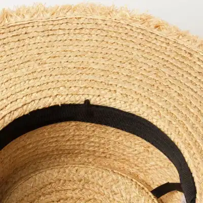 Handwoven straw sun hat perfect for summer accessory. Stylish, lightweight, and breathable with a black ribbon detail. Ideal for travel, beach, or casual outings.