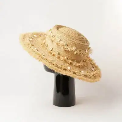Stylish straw sun hat with shell embellishments, perfect for summer and outdoor activities, providing sun protection and trendy look. Ideal for beach, garden, or vacation wear.