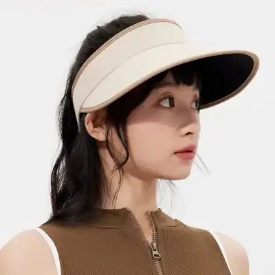 Elegant beige visor hat with wide brim, perfect for sun protection and fashion. Ideal accessory for outdoor activities, offering both style and comfort.