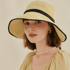Elegant sun hat with wide brim, perfect for summer protection and style. Features a black ribbon detail, ideal for fashion-conscious adults looking for sun protection accessories.