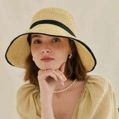 Stylish wide-brim straw sun hat with black trim, perfect for summer fashion, outdoor activities, beach, poolside, sun protection, and stylish accessories.