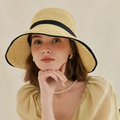 Stylish wide-brim straw sun hat with black trim, perfect for summer fashion, outdoor activities, beach, poolside, sun protection, and stylish accessories.