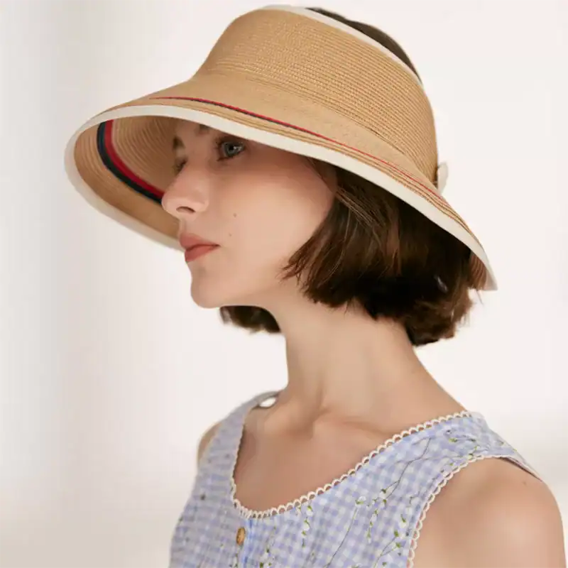 Stylish beige sun hat with wide brim, perfect for summer outdoor activities and sun protection.