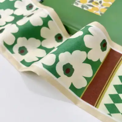 Stylish green and cream floral handkerchief featuring elegant flower patterns, perfect accessory for a fresh, nature-inspired look.