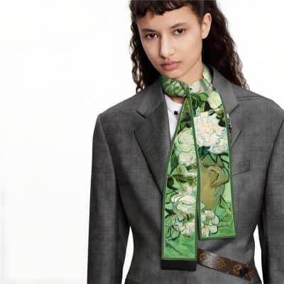 A stylish floral scarf with vibrant green and white flowers, ideal for enhancing women's business or casual attire. Made from high-quality fabric, it offers both comfort and elegance.