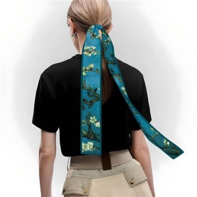 Vibrant blue silk scarf with floral design, perfect for stylish women’s accessories. Elevate your outfit with luxury satin scarves from Monalisa Medical’s exclusive collection.