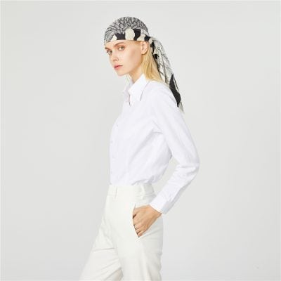 Stylish woman in white shirt and headscarf, perfect for eye care fashion or optical store branding. Elegant and modern look suitable for optometry or ophthalmology branding.