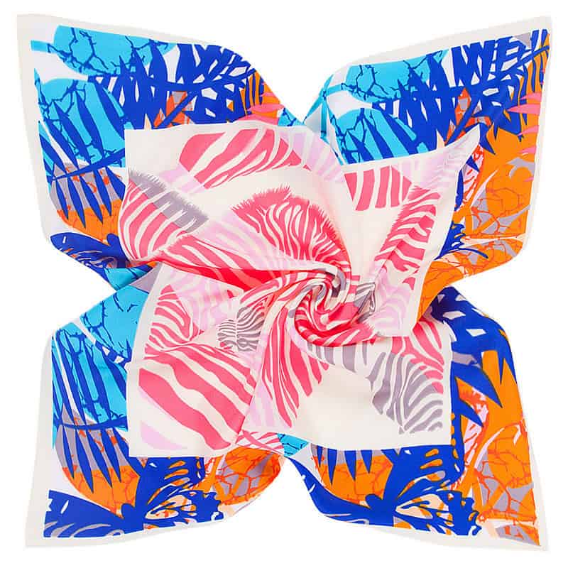 Bright, colorful floral patterned scarf with pink, white, orange, and blue leaf designs, perfect for fashion accessories.