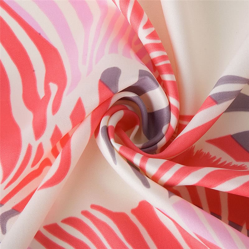 Bright, colorful fabric with bold pink, purple, and white abstract patterns, perfect for stylish accessories and clothing.