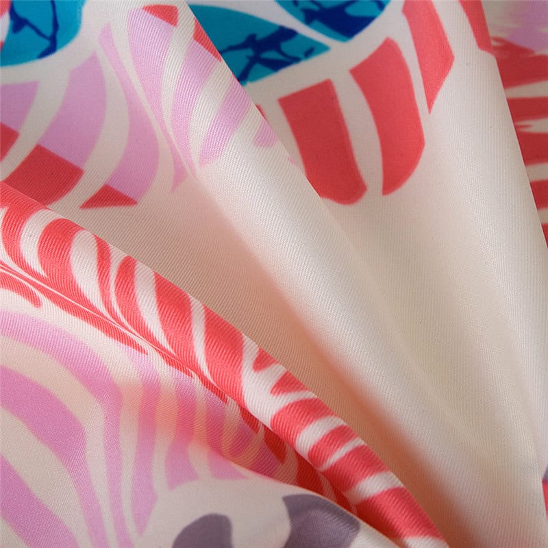 Colorful floral patterned fabric for stylish accessories or clothing, showcasing vivid pink, purple, and red hues with intricate designs perfect for eye-catching fashion statement pieces.