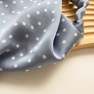 Light blue fabric polka dot headband, stylish and comfortable fashion accessory. Perfect for casual wear, sports, or hair styling needs.