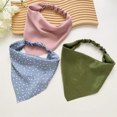 Colorful fabric headbands featuring pink, blue polka dot, and green textures for fashion accessories.
