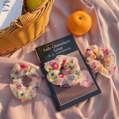 Colorful embroidered floral hair scrunchies made from soft fabric, perfect for stylish hairstyles and accessories.