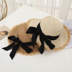 Elegant wide-brim straw hats with black ribbons, perfect for sun protection and fashion. Ideal accessories for the beach, vacation, or outdoor events to enhance your summer wardrobe.