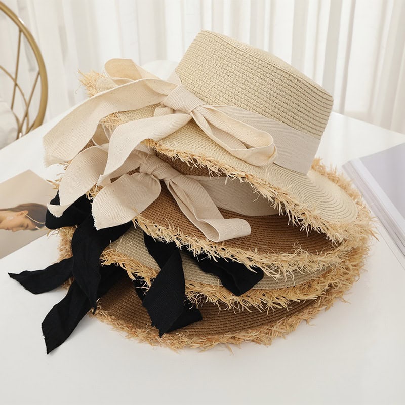Stylish wide-brim straw hats perfect for sun protection and fashion accessories, ideal for outdoor activities or beach outings. Light and comfortable, available in various neutral tones.