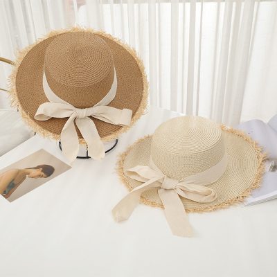 Stylish straw sun hat with a wide brim and elegant bow, perfect for summer outdoor activities and sun protection. Lightweight and breathable, ideal for fashion-conscious individuals.