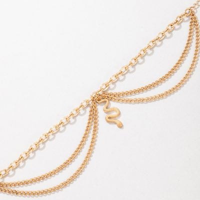 Elegant gold layered chain necklace with snake pendant, perfect for fashionable accessories and jewelry gifts.