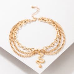 Elegant layered gold snake pendant necklace with multiple chain styles for women. Perfect accessory for fashion and statement jewelry enthusiasts.