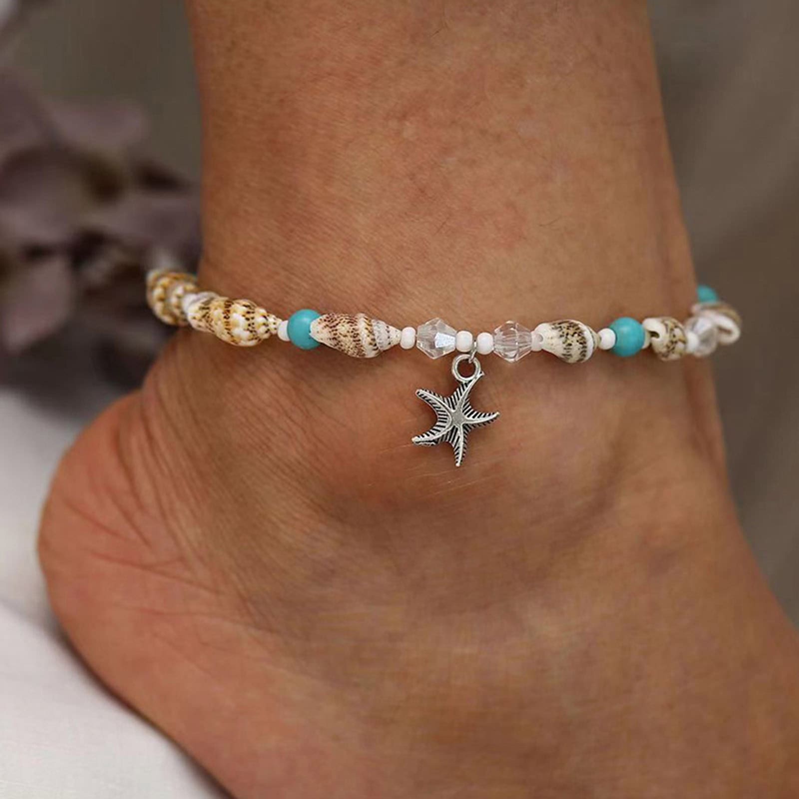 Seashell and turquoise beaded bracelet featuring a silver starfish charm, perfect for beach lovers and summer accessories. Handcrafted jewelry ideal for casual or nautical-inspired outfits.