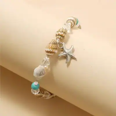 Sea shell and starfish charm bracelet with turquoise accents, lightweight and beach-inspired accessory perfect for summer or casual wear.