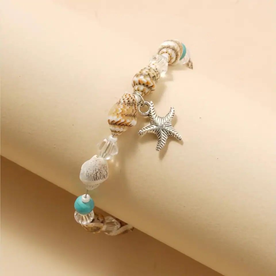 Sea shell and starfish charm bracelet with turquoise accents, lightweight and beach-inspired accessory perfect for summer or casual wear.