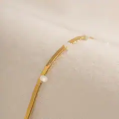 A beautiful gold necklace featuring delicate pearl accents, perfect for stylish jewelry lovers. High-quality craftsmanship with timeless design for any occasion.