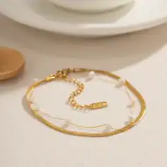 Delicate gold necklace and bracelet with pearl accents, perfect for stylish accessorizing and gifting. Crafted for elegance and durability, ideal for enhancing any outfit with a touch of sophistication.