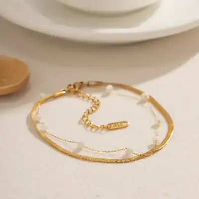 Delicate gold necklace and bracelet with pearl accents, perfect for stylish accessorizing and gifting. Crafted for elegance and durability, ideal for enhancing any outfit with a touch of sophistication.