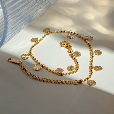 Close-up of a gold necklace with circular pendant charms and matching bracelet, perfect for fashion accessories and jewelry shopping at Monalisa Medical Store.