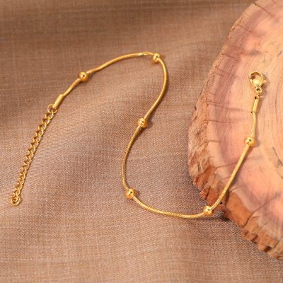 Gold plated necklace with spherical accents, perfect for fashionable women. Ideal accessory for daily wear or special occasions, showcasing stylish and luxury jewelry.