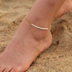 Delicate gold anklet with white beads, perfect for beach or summer accessories, stylish jewelry for women.