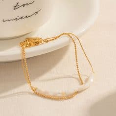 A beautiful gold and white beaded necklace displayed on a plate, showcasing its delicate design and versatile style, perfect for accessories, gifts, or everyday wear to elevate your look.