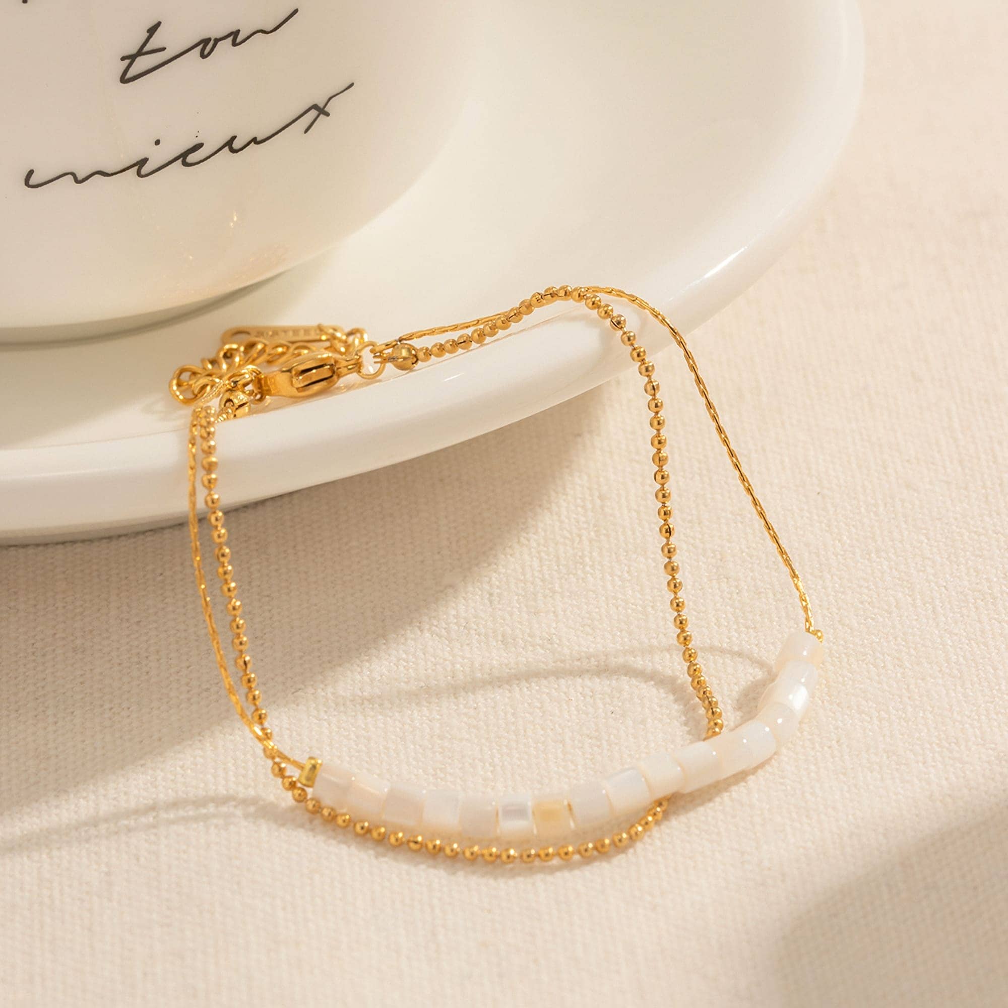 A beautiful gold and white beaded necklace displayed on a plate, showcasing its delicate design and versatile style, perfect for accessories, gifts, or everyday wear to elevate your look.